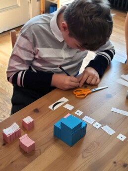 Lyonsgate Montessori School Elementary student working on cubing.