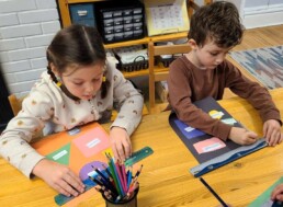First Year Lyonsgate Montessori School Elementary students creating geometry posters.