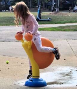 Lyonsgate Montessori School Elementary student riding the wild snail at recreation time.