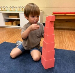 A first-year Lyonsgate Montessori School Casa student working with the iconic Montessori Pink Tower material.