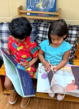 Lyonsgate Montessori School Casa students looking at books together.