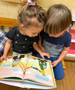 Lyonsgate Montessori School Casa students reading together.