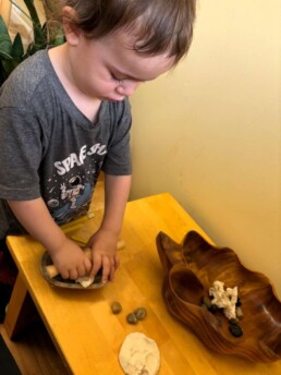 Lyonsgate Montessori Toddler student exploring sensory play.