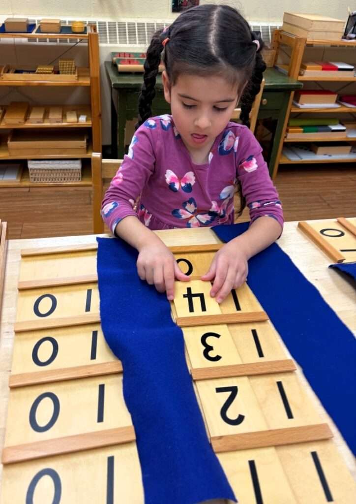 Lyonsgate Montessori School Casa student working with the Montessori Teen Boards material.