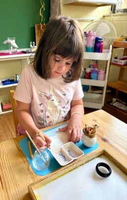 Lyonsgate Montessori School Casa student working with watercolour pencils.