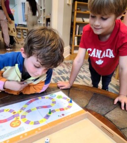 Lyonsgate Montessori School Elementary students practicing French with a French-language board game.