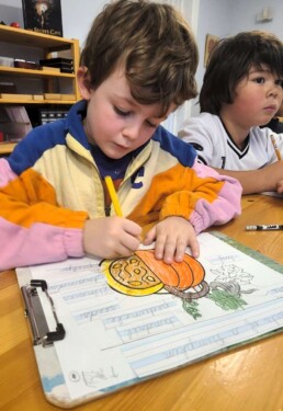 Lyonsgate Montessori School Elementary student labelling the parts of a pumpkin.