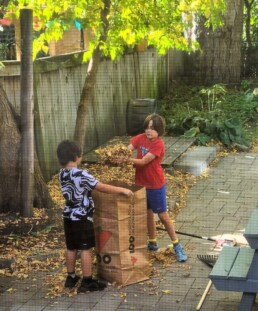 Lyonsgate Montessori School Elementary students engaged in some practical life work by taking care of their school's back yard.