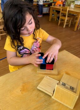 Lyonsgate Montessori School Casa student working with the Montessori Binomial Cube material.