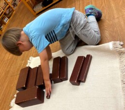 Lyonsgate Montessori School Casa student working with the Montessori Brown Stairs material.
