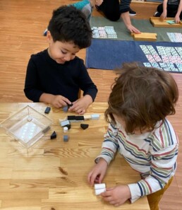 Lyonsgate Montessori School Casa students working together to build, while also being introduced to various geometric shapes.