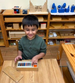 Lyonsgate Montessori School Casa student setting up to work with a Montessori Colour Box material.