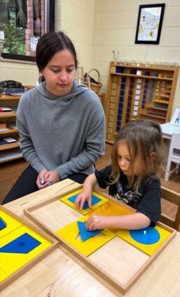 Lyonsgate Montessori School Casa student receiving a presentation with the Montessori Geometry Cabinet material.