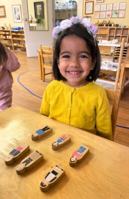 Lyonsgate Montessori School Casa student learning the French vocabulary for members of the family.