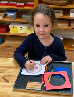 Lyonsgate Montessori School Casa student working with the Montessori Metal Inset material (sadly, they are not metal inseCts, which many young children call them).