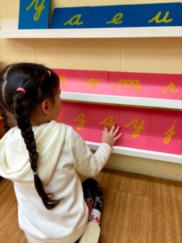 Lyonsgate Montessori School Casa student exploring the Montessori Sandpaper Letters material.