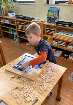 This Lyonsgate Montessori School Casa student is starting the big task of counting from 1-100.