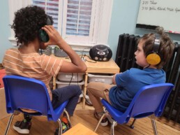 Lyonsgate Montessori School Elementary students listening to music together.