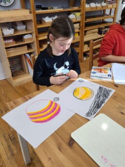 Lyonsgate Montessori School Elementary student using some art Inspiration from Listening to Holst.