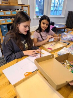 Lyonsgate Montessori School Elementary students creating crafts for their seasonal charity outreach project.