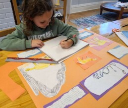 Lyonsgate Montessori School Elementary student working on her lions poster project.