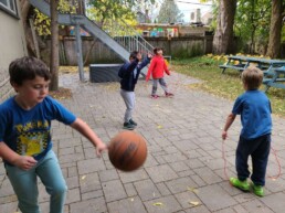 Lyonsgate Montessori School Elementary students enjoying some P.E. practice in the back yard.