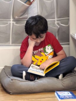 Lyonsgate Montessori School Elementary student enjoying his mid-day quiet reading time.