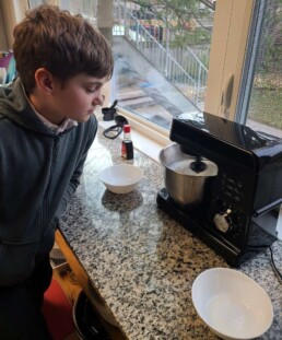 Lyonsgate Montessori School Elementary student whipping meringue for soupees.