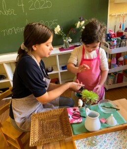 Lyonsgate Montessori School Casa student working with her Montessori guide on the Montessori Flower Arranging activity. Thank you to our families for their beautiful contributions of bouquets for this activity.