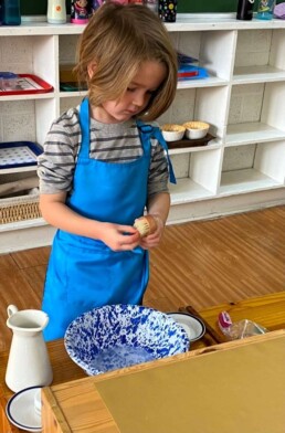 Lyonsgate Montessori School Casa student and a Montessori handwashing activity.