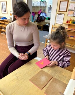 Lyonsgate Montessori School Casa student receiving a presentation with the Montessori Sandpaper Letters material.