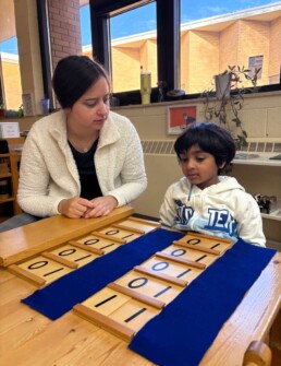 Lyonsgate Montessori School Casa student receiving a presentation of the Montessori Ten Boards material.
