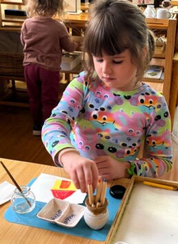 Lyonsgate Montessori School Casa student creating art with watercolour pencils.