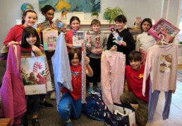 Lyonsgate Montessori School Elementary students with the Holiday Hope gifts they purchased with the proceeds from their charity fundraising sale.