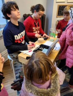 Lyonsgate Montessori School Elementary students running the check out for their charity outreach project fundraising sale.