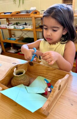 Lyonsgate Montessori School Casa student working on a holiday craft project that mirrors a Montessori fine motor skill development activity.