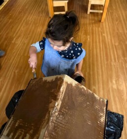 Lyonsgate Montessori School Toddler student painting a 