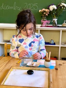 Lyonsgate Montessori School Casa student working with watercolour paint pencils.
