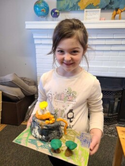 Lyonsgate Montessori School Elementary student showing her model of Mount Olympus and home of the Olympians.