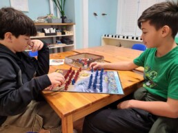 Lyonsgate Montessori School Elementary students playing Stratego during cold weather indoor recreation time.