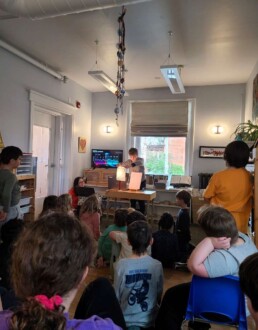 Lyonsgate Montessori School Elementary students preparing for a presentation on exoplanets with a spectrogram demo.