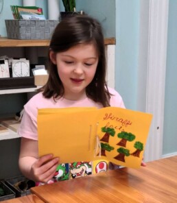 Lyonsgate Montessori School Elementary student reviewing her first project booklet.