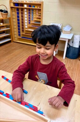 Lyonsgate Montessori School Casa student working with the Montessori Small Number Rods material.
