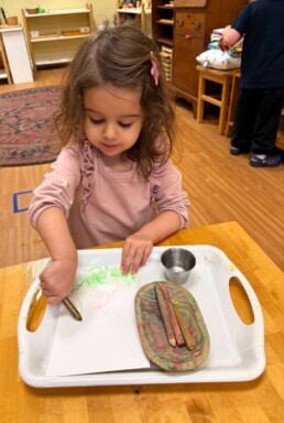 Lyonsgate Montessori School Toddler student beginning to incorporate detail into her artistic creations with watercolour pencils.