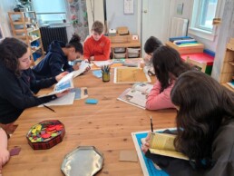 Lyonsgate Montessori School Elementary students engaged in an ancient Greece research party.