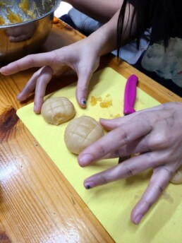 Lyonsgate Montessori School Elementary students shaping and scoring ong lai tarts.