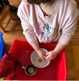 Lyonsgate Montessori School Toddler student at the handwashing station activity, which is practice completing multi-step sequences.