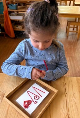 Lyonsgate Montessori School Casa student building some exquisite fine motor skills with a pipe cleaner craft.