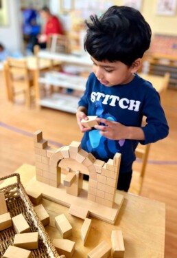 Lyonsgate Montessori School Casa student building the Montessori Roman Arch material.