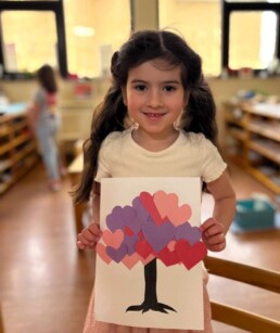 Lyonsgate Montessori School Casa student making a Valentine's Day craft.